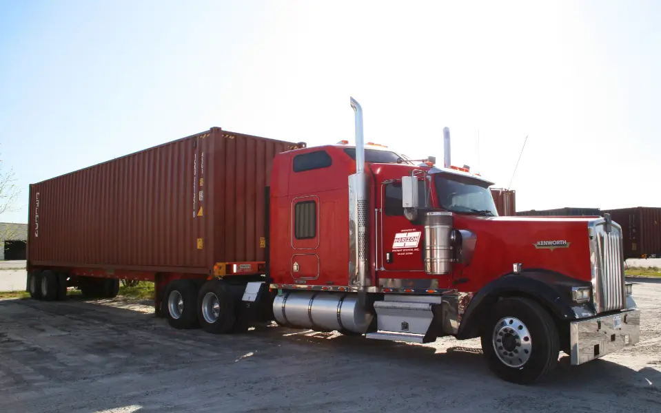 A red truck with a large trailer on the back.